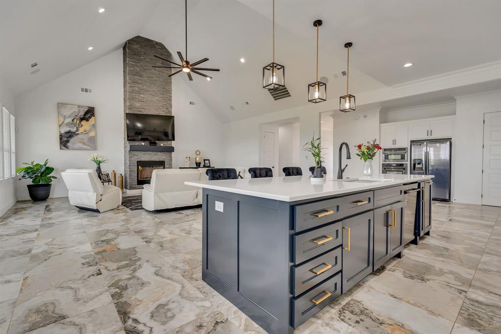 7299 Tom Trail Krum, TX 76249 - Photo 4 of 34 a kitchen with stainless steel appliances kitchen island granite countertop a sink and a refrigerator