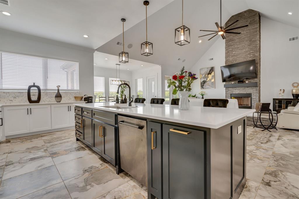 7299 Tom Trail Krum, TX 76249 - Photo 7 of 34 a kitchen with stainless steel appliances kitchen island granite countertop a sink and cabinets
