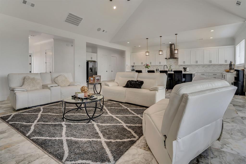 7299 Tom Trail Krum, TX 76249 - Photo 8 of 34 a living room with furniture a rug and white kitchen