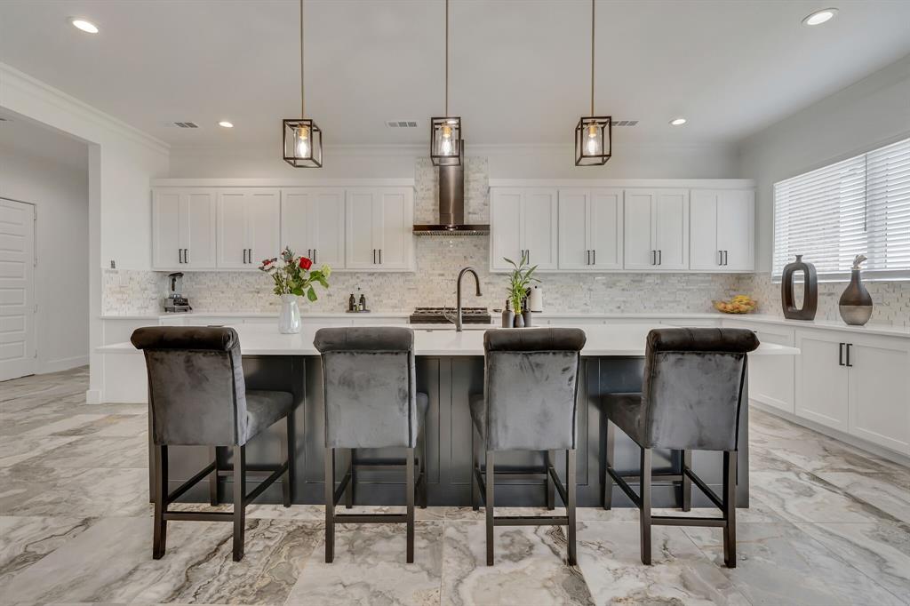 7299 Tom Trail Krum, TX 76249 - Photo 10 of 34 a kitchen with a dining table chairs and white cabinets