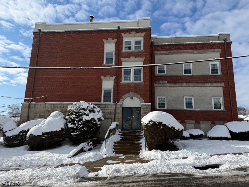 103 Park Avenue, Unit 206 Summit, NJ 07901 - Photo 1 of 25 a front view of a house with cars parked