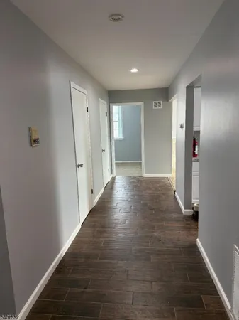 a view of hallway with wooden floor