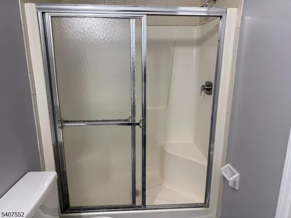 a bathroom with a glass shower door