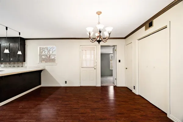 a view of a kitchen with a dishwasher cabinets and wooden floor