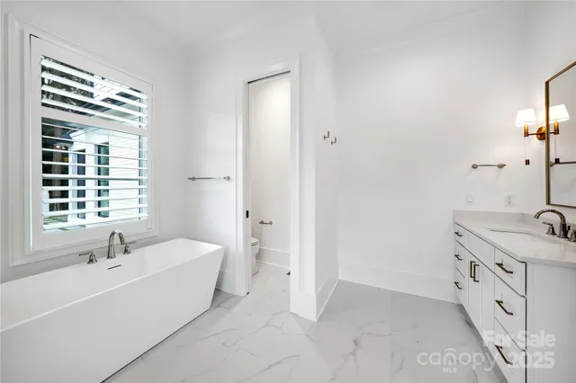 a bathroom with a tub sink and mirror