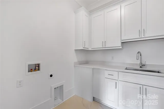 a kitchen with white cabinets