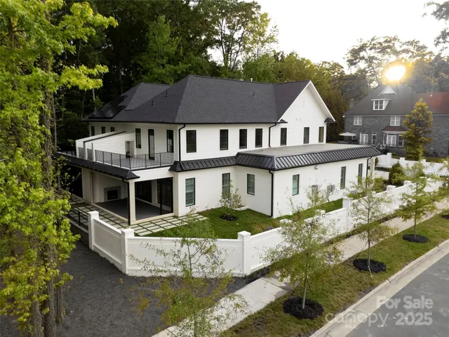a front view of a house with a yard and potted plants