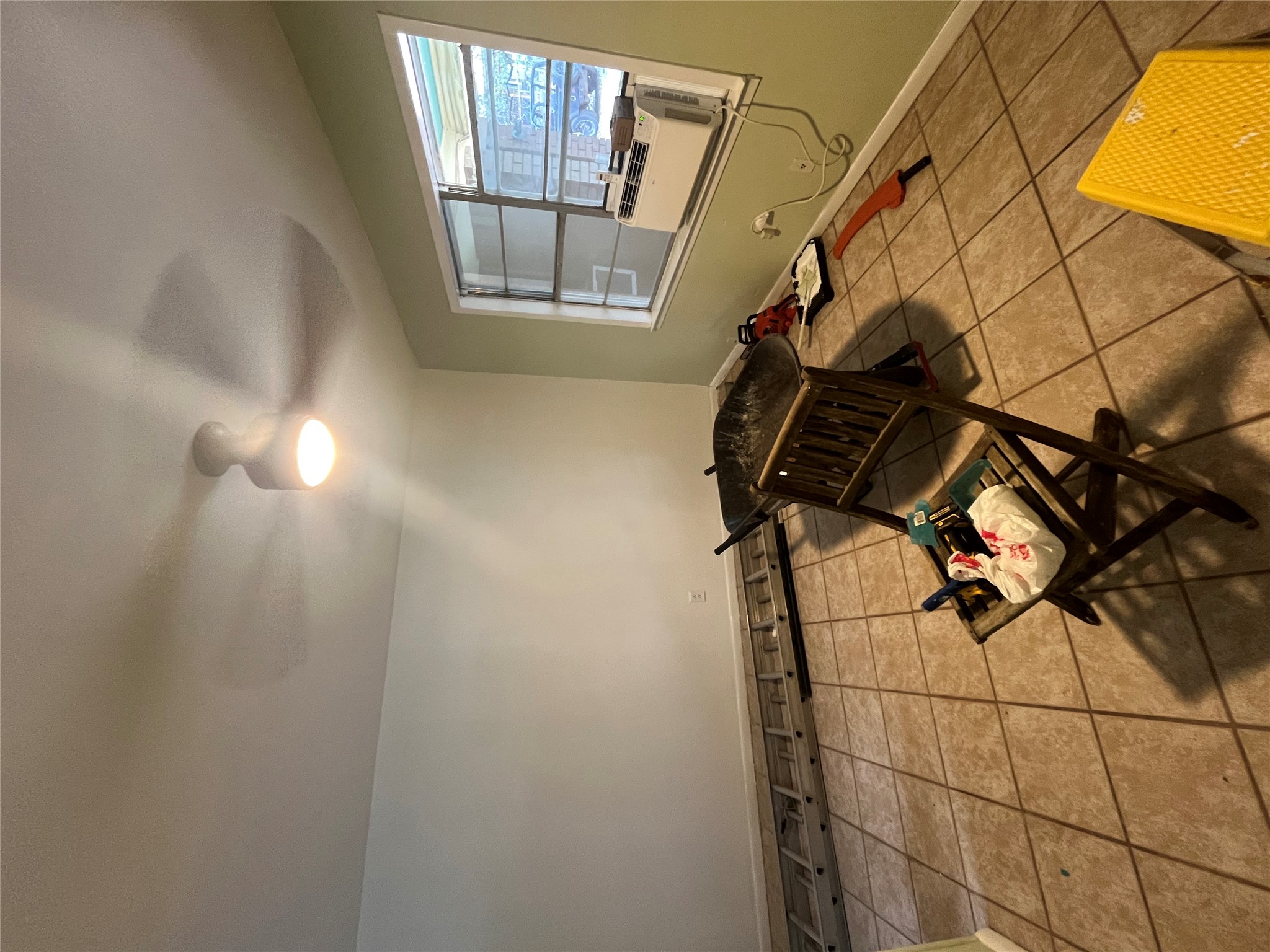 1607 Lightsey Road, Unit A Austin, TX 78704 - Photo 5 of 17 Room featuring neutral-toned tile flooring, light-colored walls, a ceiling fan with integrated lighting, and a window providing natural light