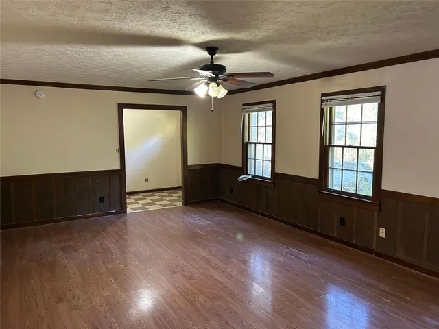 a view of a yard with plants and trees