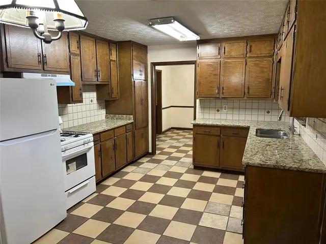 a view of a room with wooden floor and furniture