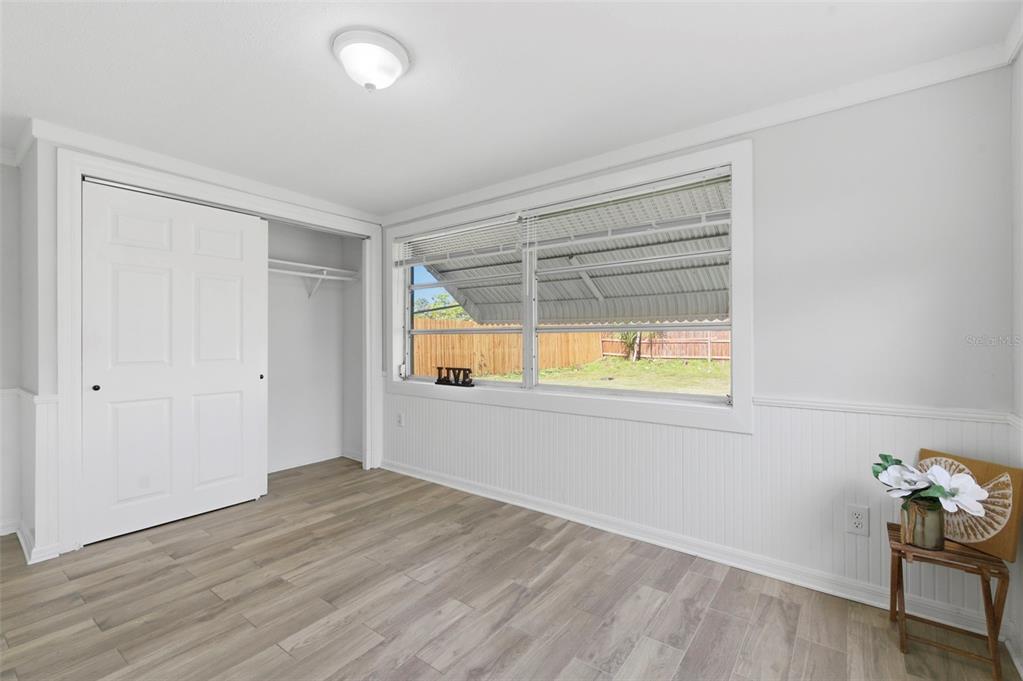 9033 Pegasus Avenue Port Richey, FL 34668 - Photo 22 of 56 wooden floor in an empty room with a window