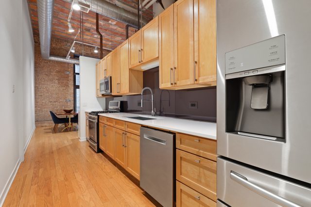 222 South Racine Avenue, Unit 207 Chicago, IL 60607 - Photo 12 of 27 a kitchen with stainless steel appliances granite countertop a sink a stove and cabinets