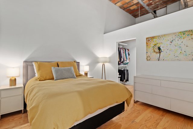 222 South Racine Avenue, Unit 207 Chicago, IL 60607 - Photo 14 of 27 a bedroom with a bed and painting on the wall