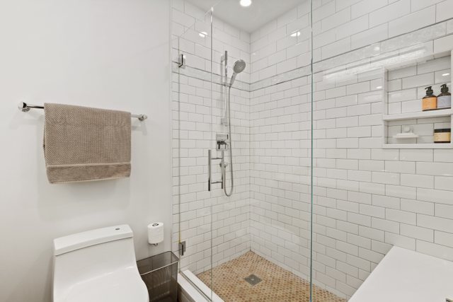 222 South Racine Avenue, Unit 207 Chicago, IL 60607 - Photo 20 of 27 a bathroom with a toilet and shower