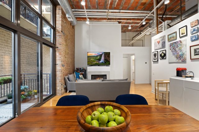 222 South Racine Avenue, Unit 207 Chicago, IL 60607 - Photo 3 of 27 a room with lots of white furniture and wooden floor