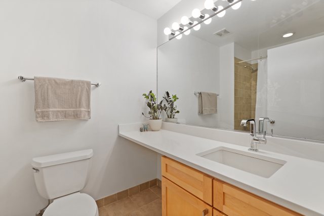 222 South Racine Avenue, Unit 207 Chicago, IL 60607 - Photo 25 of 27 a bathroom with a toilet a sink and mirror