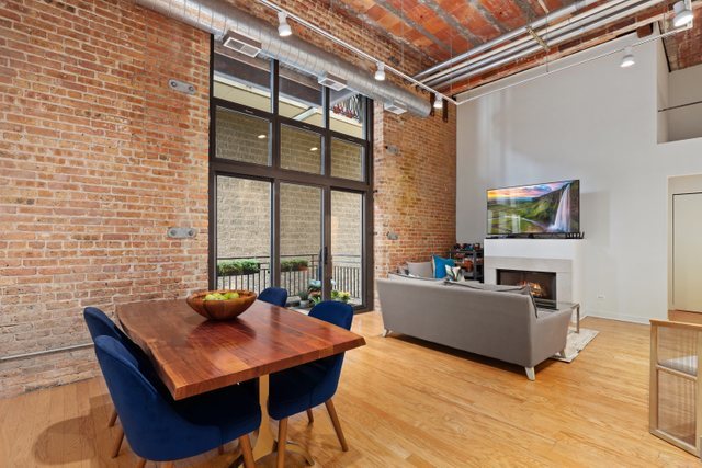 222 South Racine Avenue, Unit 207 Chicago, IL 60607 - Photo 4 of 27 a living room with furniture and a flat screen tv
