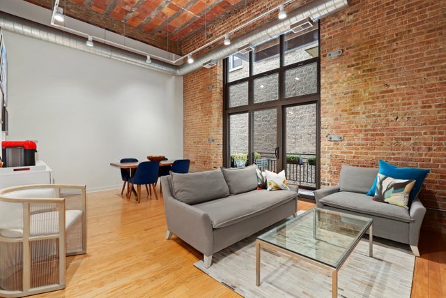 222 South Racine Avenue, Unit 207 Chicago, IL 60607 - Photo 5 of 27 a living room with furniture and a large window