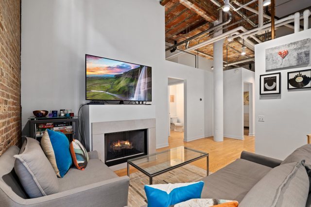 222 South Racine Avenue, Unit 207 Chicago, IL 60607 - Photo 7 of 27 a living room with furniture and a fireplace