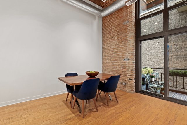 222 South Racine Avenue, Unit 207 Chicago, IL 60607 - Photo 8 of 27 a view of a dining room with furniture and a window