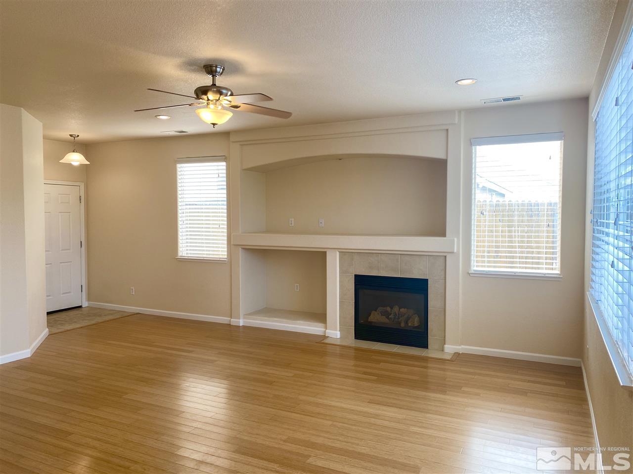 10265 Robilee Drive Reno, NV 89521 - Photo 3 of 17 a view of an empty room with wooden floor and a window