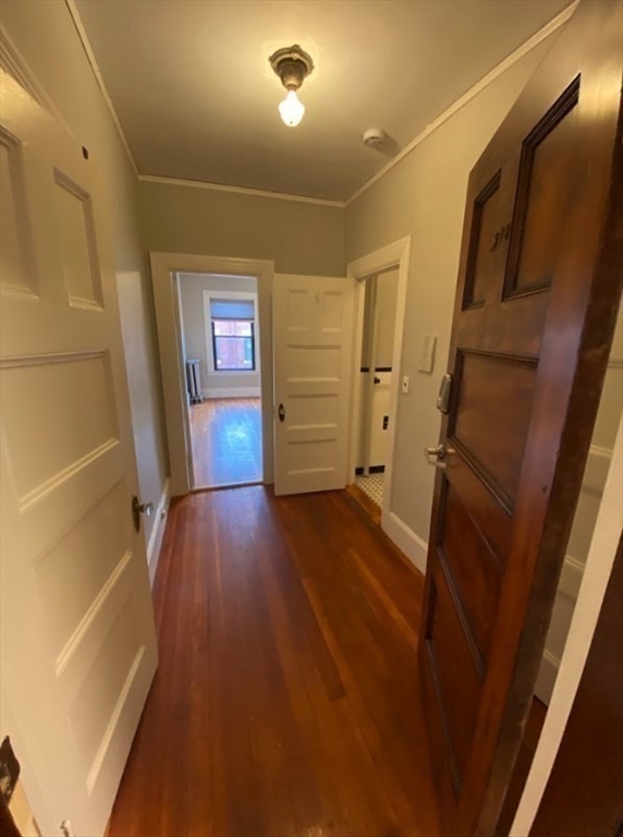 9 Sewall Avenue, Unit 312 Brookline, MA 02446 - Photo 4 of 9 a view of hallway with stairs and wooden floor