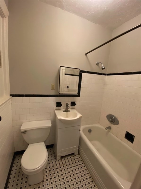 9 Sewall Avenue, Unit 312 Brookline, MA 02446 - Photo 7 of 9 a bathroom with a sink a toilet and bathtub