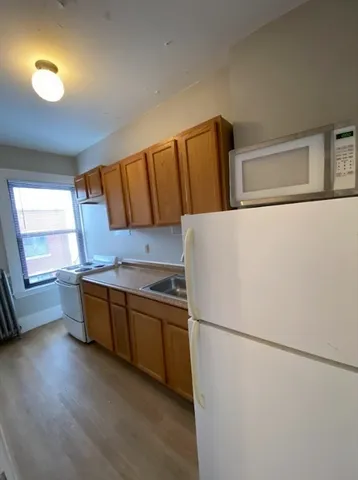 a kitchen with stainless steel appliances a refrigerator and a sink