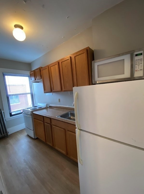9 Sewall Avenue, Unit 312 Brookline, MA 02446 - Photo 8 of 9 a kitchen with stainless steel appliances a refrigerator and a sink