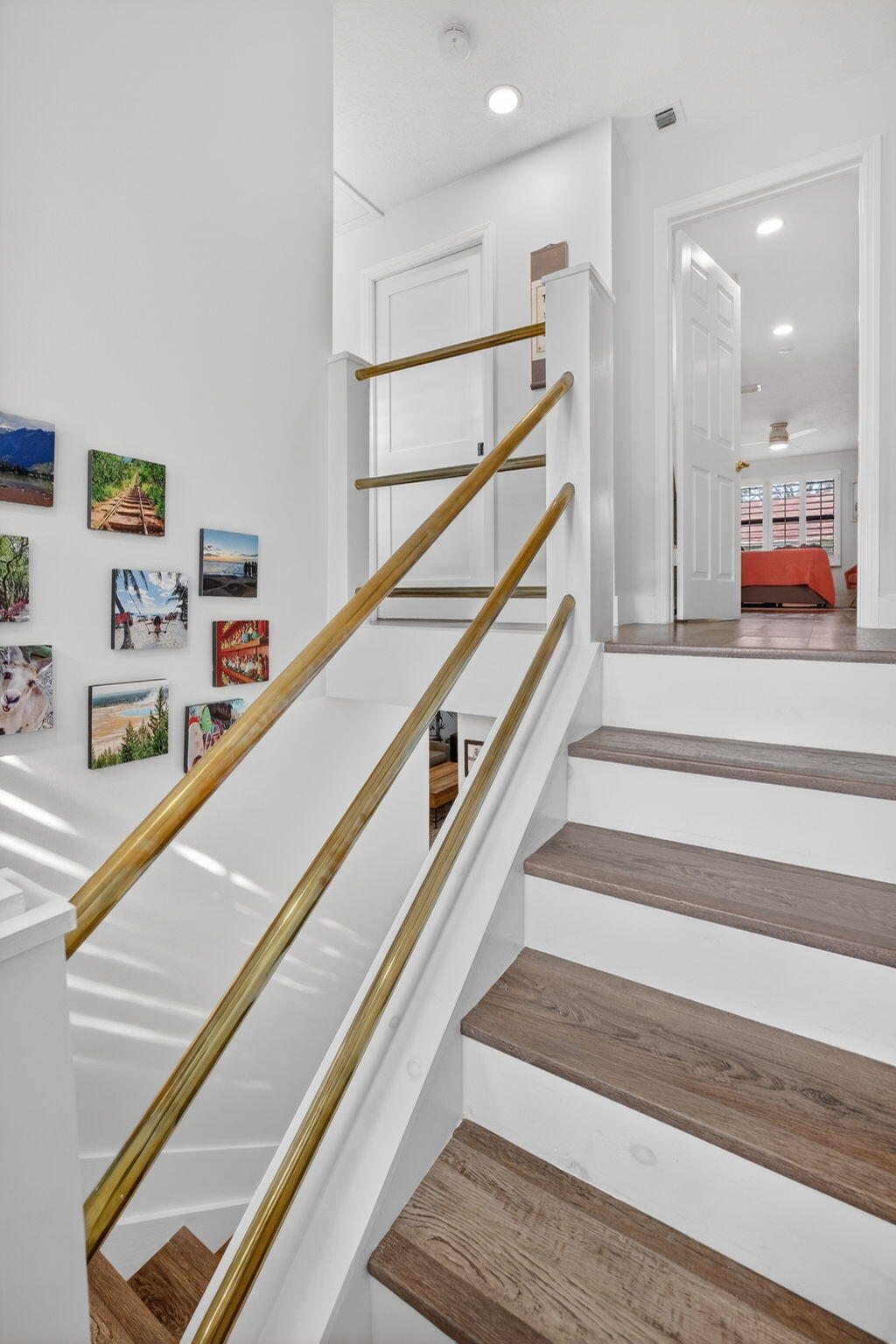 237 City View Drive, Unit 237 Fort Lauderdale, FL 33311 - Photo 30 of 81 a view of staircase with lots of frames on wall and a ceiling fan