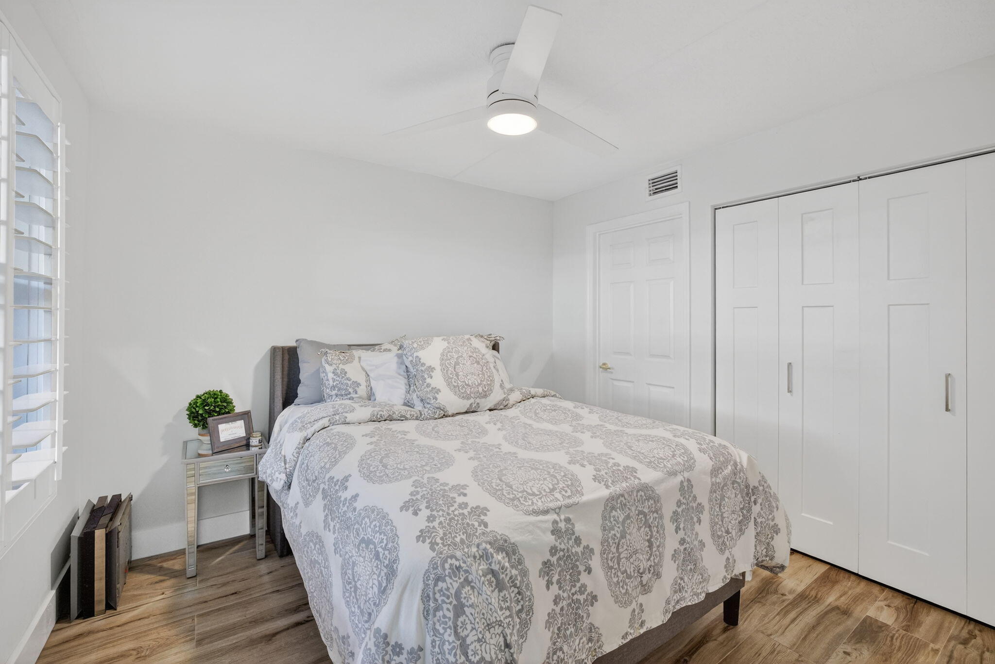 237 City View Drive, Unit 237 Fort Lauderdale, FL 33311 - Photo 52 of 81 a bedroom with a bed and wooden floor