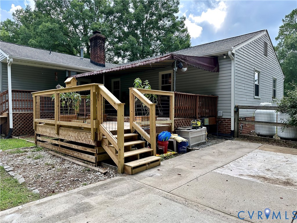 7817 Woodbrook Road Quinton, VA 23141 - Photo 22 of 28 Concrete patio attached to a large multi-level dec