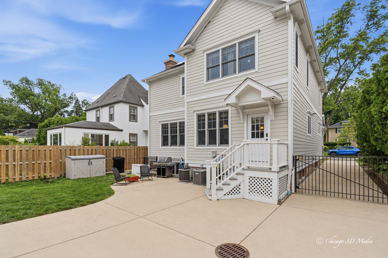 306 17th Street Wilmette, IL 60091 - Photo 40 of 48 a view of a white house with a small yard and large trees