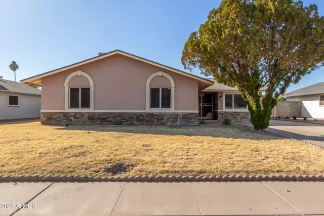 a front view of house with yard covered in the background
