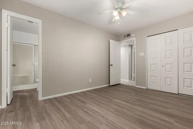 a view of an empty room with wooden floor