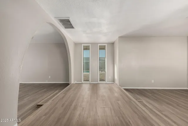 wooden floor in an empty room with a window