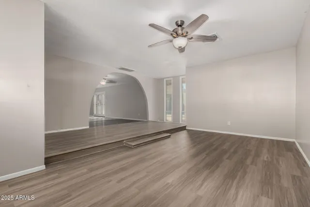 wooden floor in an empty room with a window