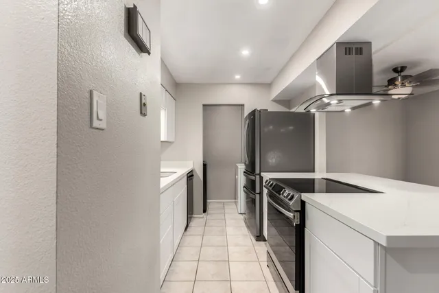 a kitchen with a refrigerator and a sink