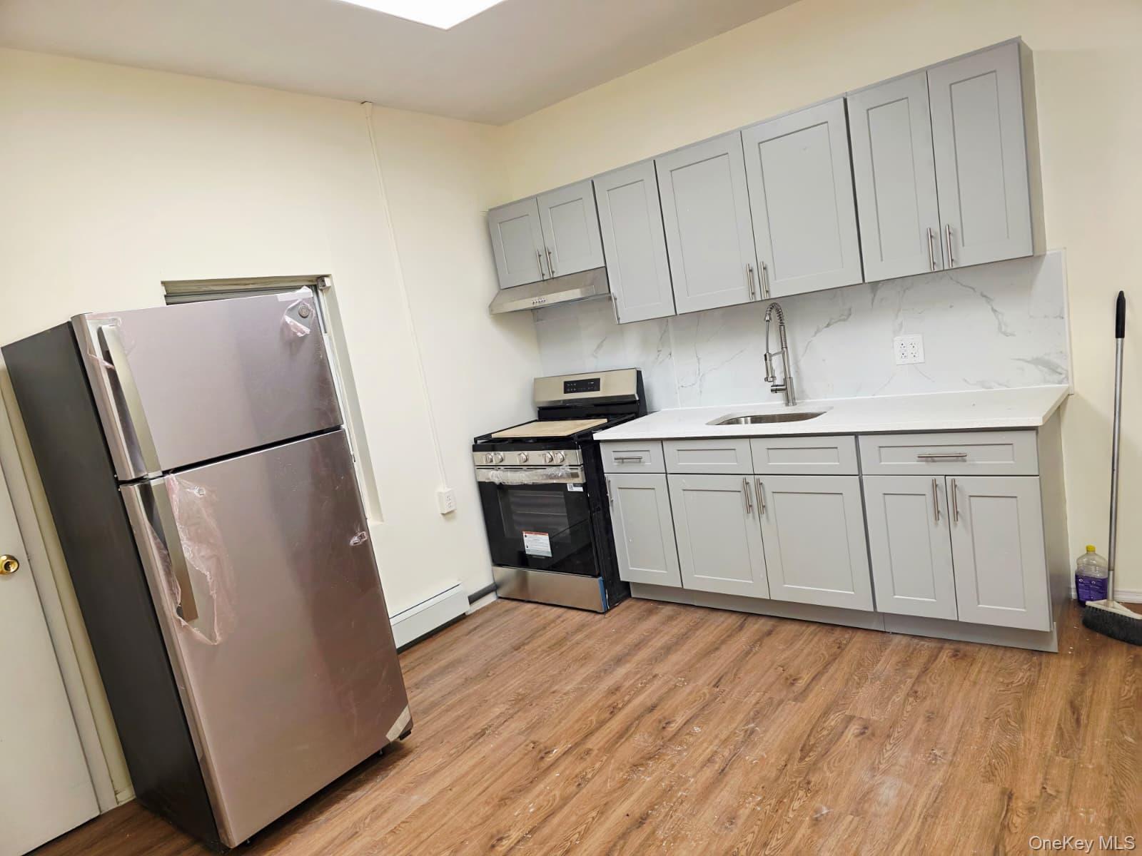 a kitchen with a refrigerator sink and cabinets