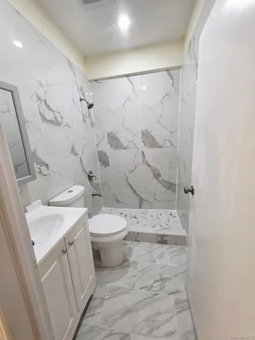 a bathroom with a toilet sink and shower