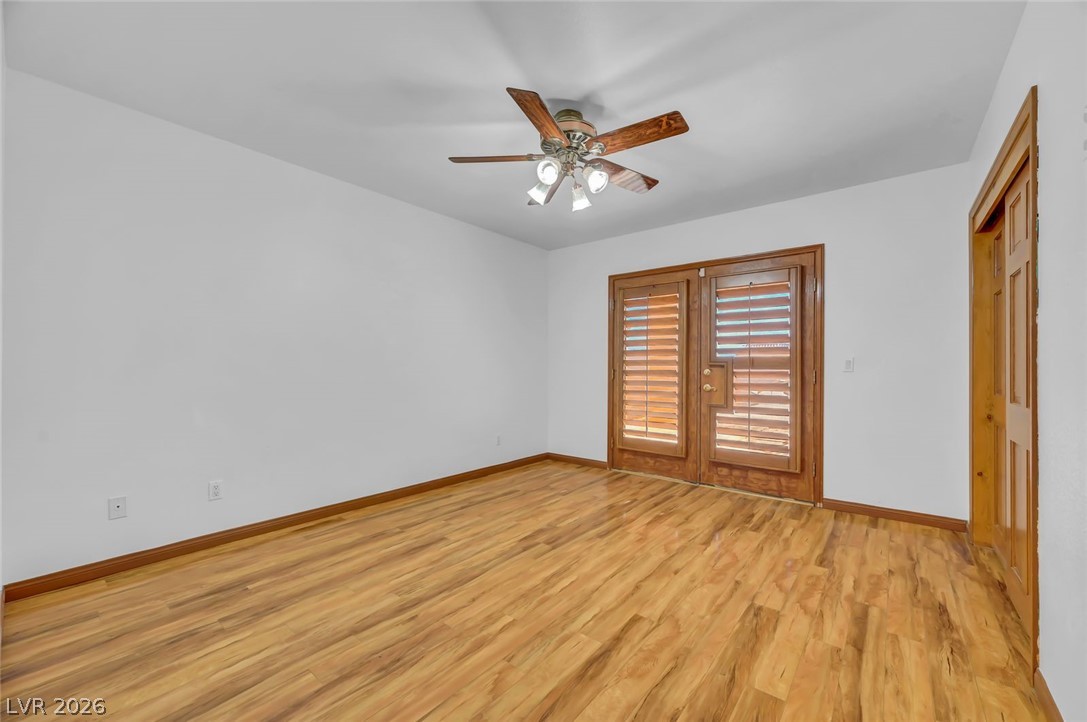 640 North Racetrack Road Henderson, NV 89015 - Photo 36 of 65 Natural wood flooring complements the private patio access with elegant French doors in this serene room.