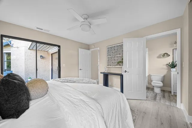 a spacious bedroom with a bed and a view of bathroom