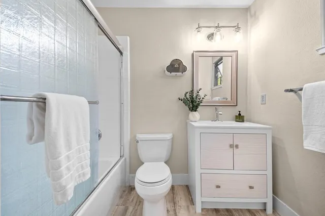 a bathroom with a toilet sink and shower