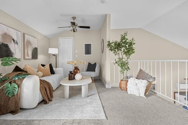 a living room with furniture and a potted plant
