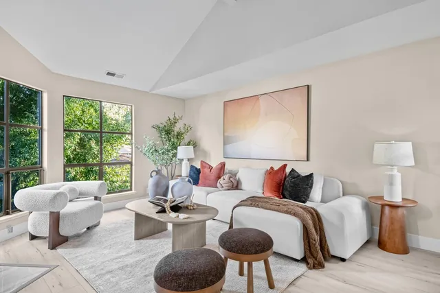 a bedroom with furniture and a large window