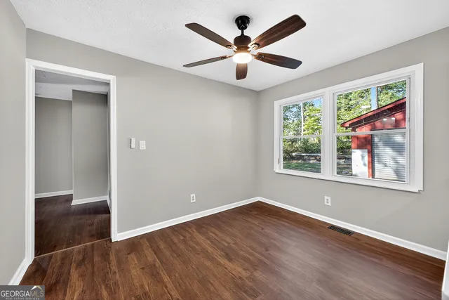 wooden floor in an empty room with a window