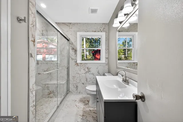 a bathroom with a sink a shower and a mirror