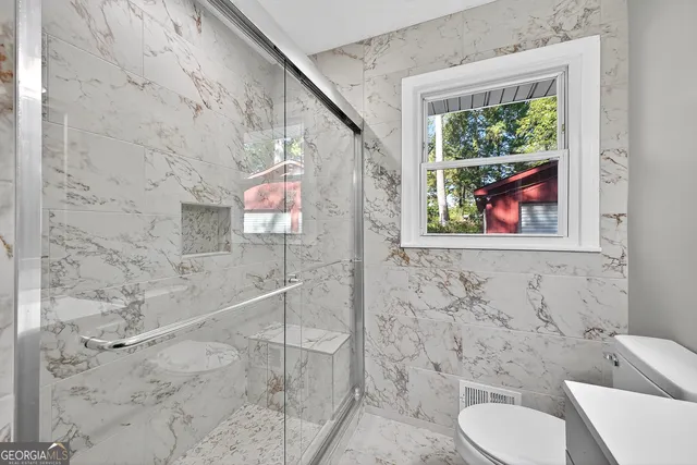 a bathroom with a toilet and a sink