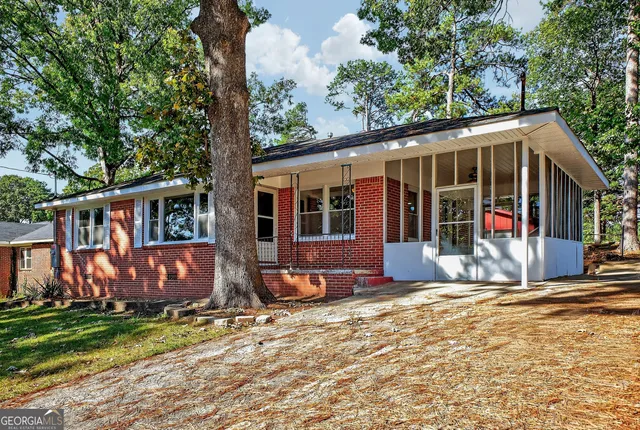 a view of house with outdoor space and garden