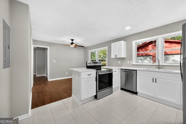 a kitchen with stainless steel appliances granite countertop a refrigerator and a stove top oven